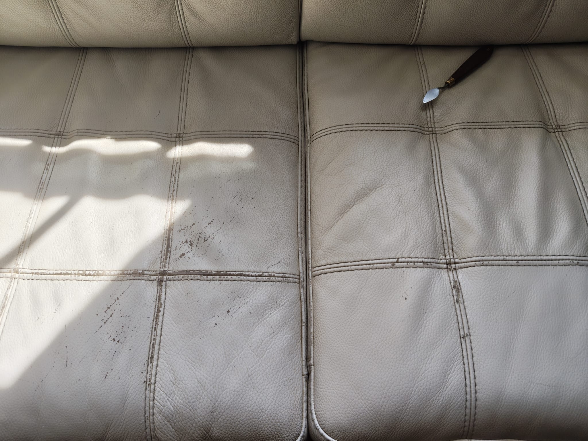 Damaged leather couch before restoration